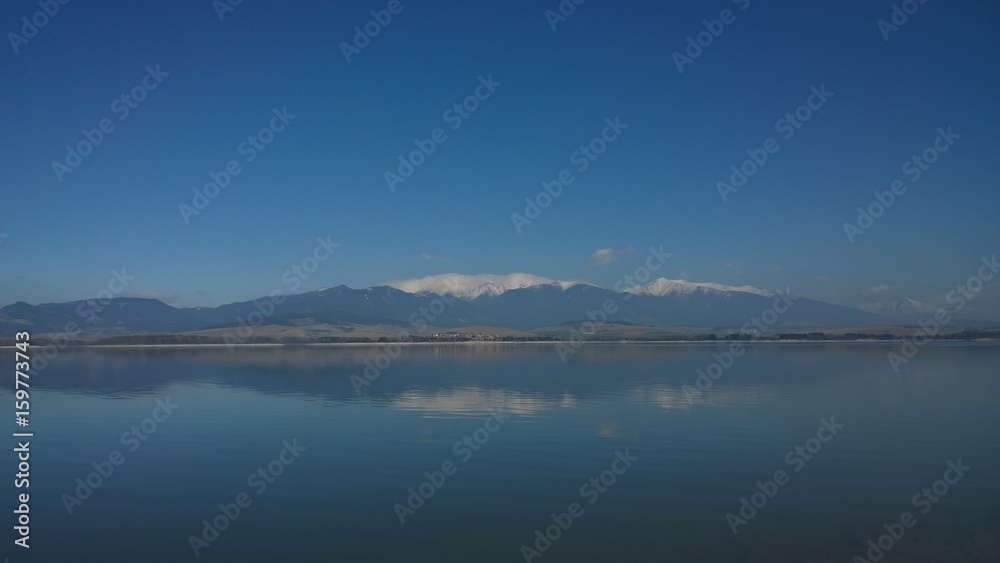 Reflection of High Tatras mountains in Liptovska Mara water reservoir. Slovakia