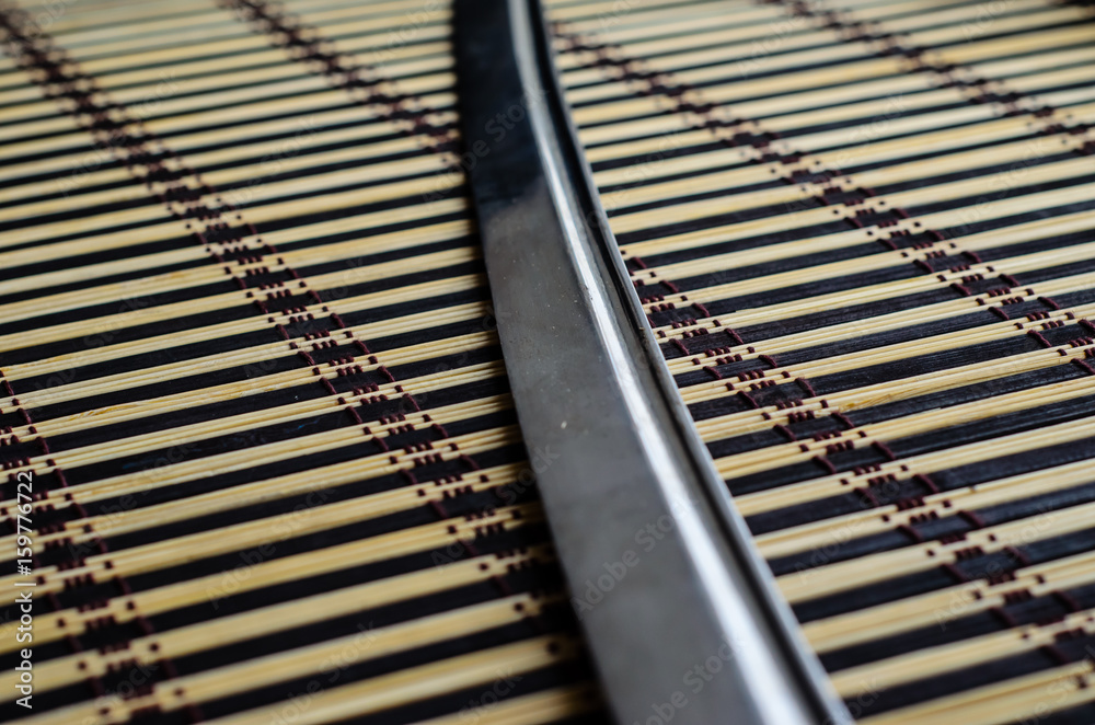 Japanese sword katana on bamboo mat Japanese sword katana on bamboo mat