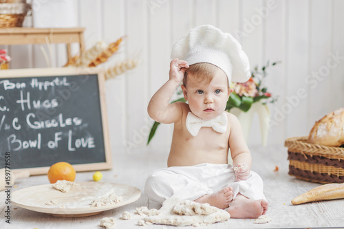 the little girl plays with the test in a bakery. the scullion in white photo