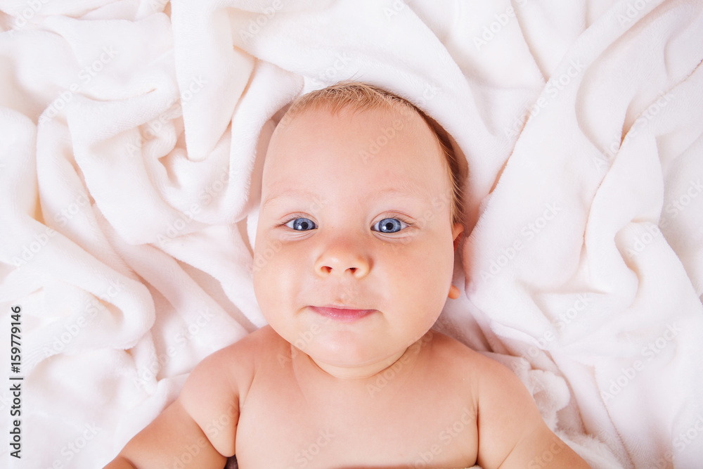Cute smiling baby under towel after bath Cute smiling baby under towel after bath