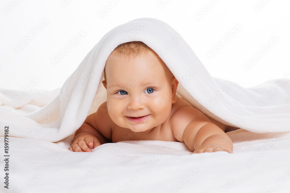 Cute smiling baby under towel after bath Cute smiling baby under towel after bath