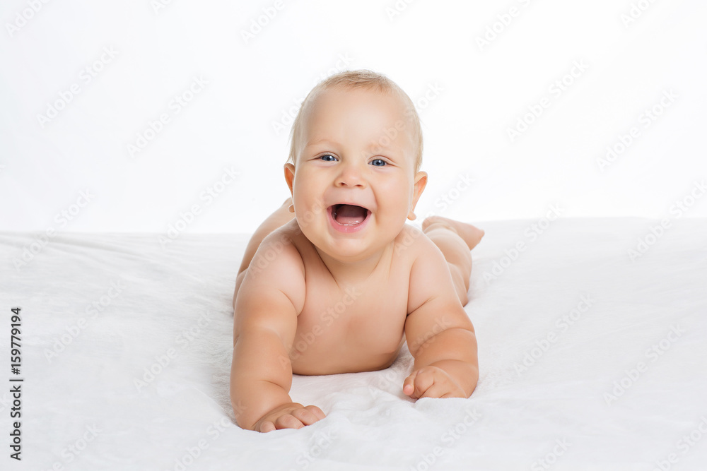 Cute smiling baby lying on towel isolated on white Cute smiling baby lying on towel isolated on white