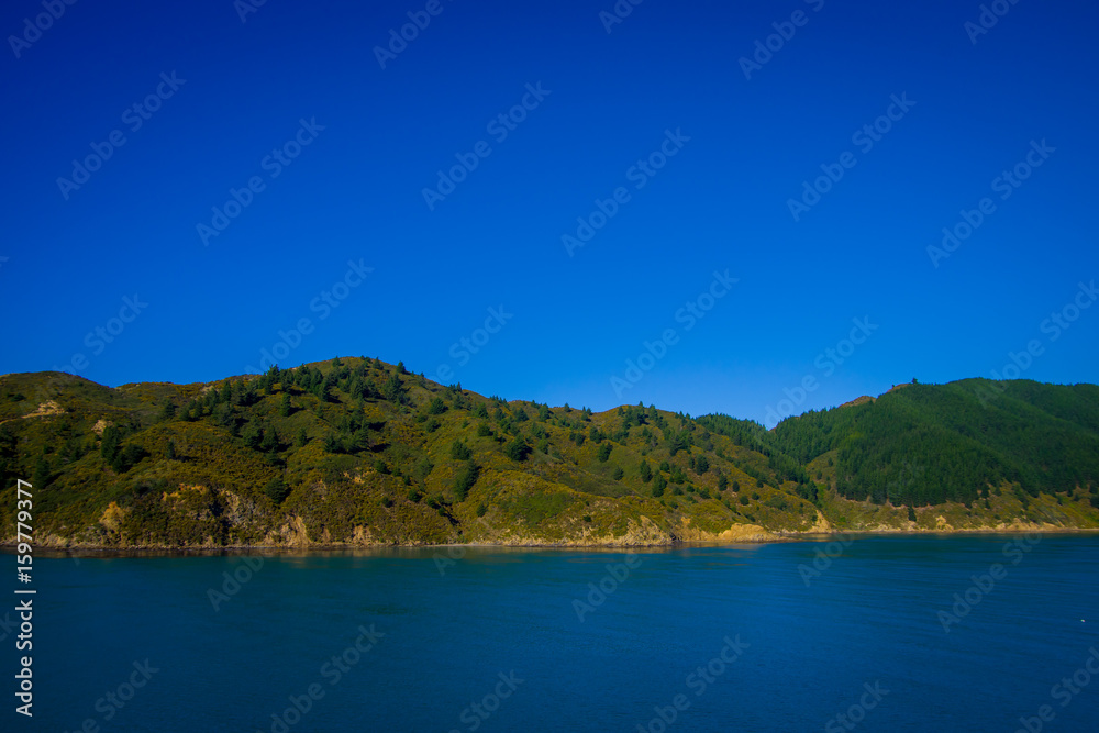 Beautiful landscape of mountain with gorgeous blue sky in a sunny day seen from ferry from north island to south island, in New Zealand