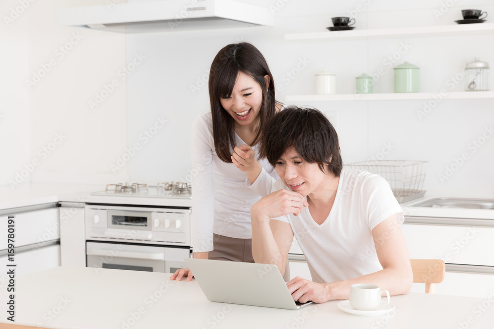young asian couple relaxing in kitchen