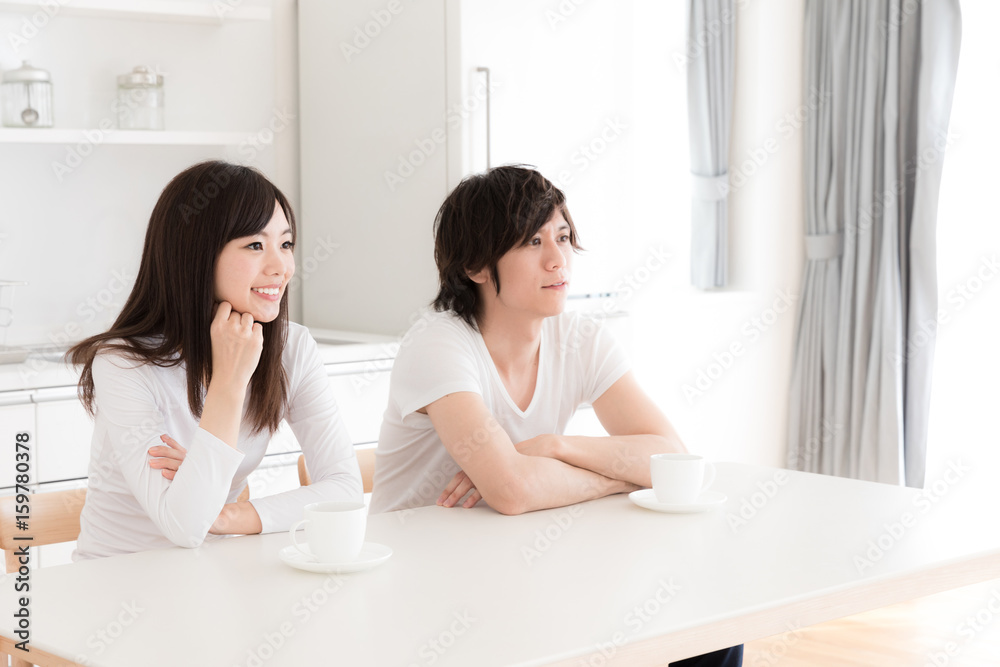 young asian couple relaxing in kitchen young asian couple relaxing in kitchen