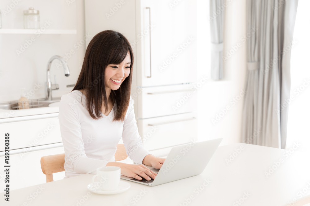 young asian woman relaxing in kitchen young asian woman relaxing in kitchen
