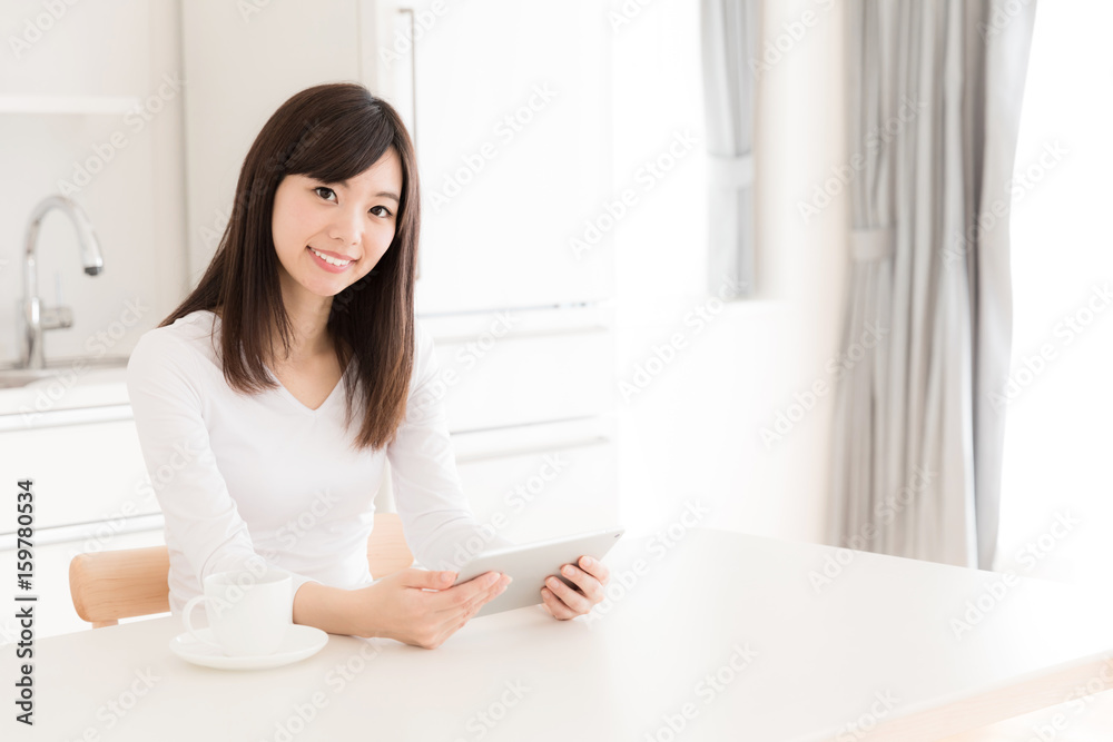 young asian woman relaxing in kitchen young asian woman relaxing in kitchen