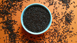 Sweet chocolate granulated in white pot on orange background top view