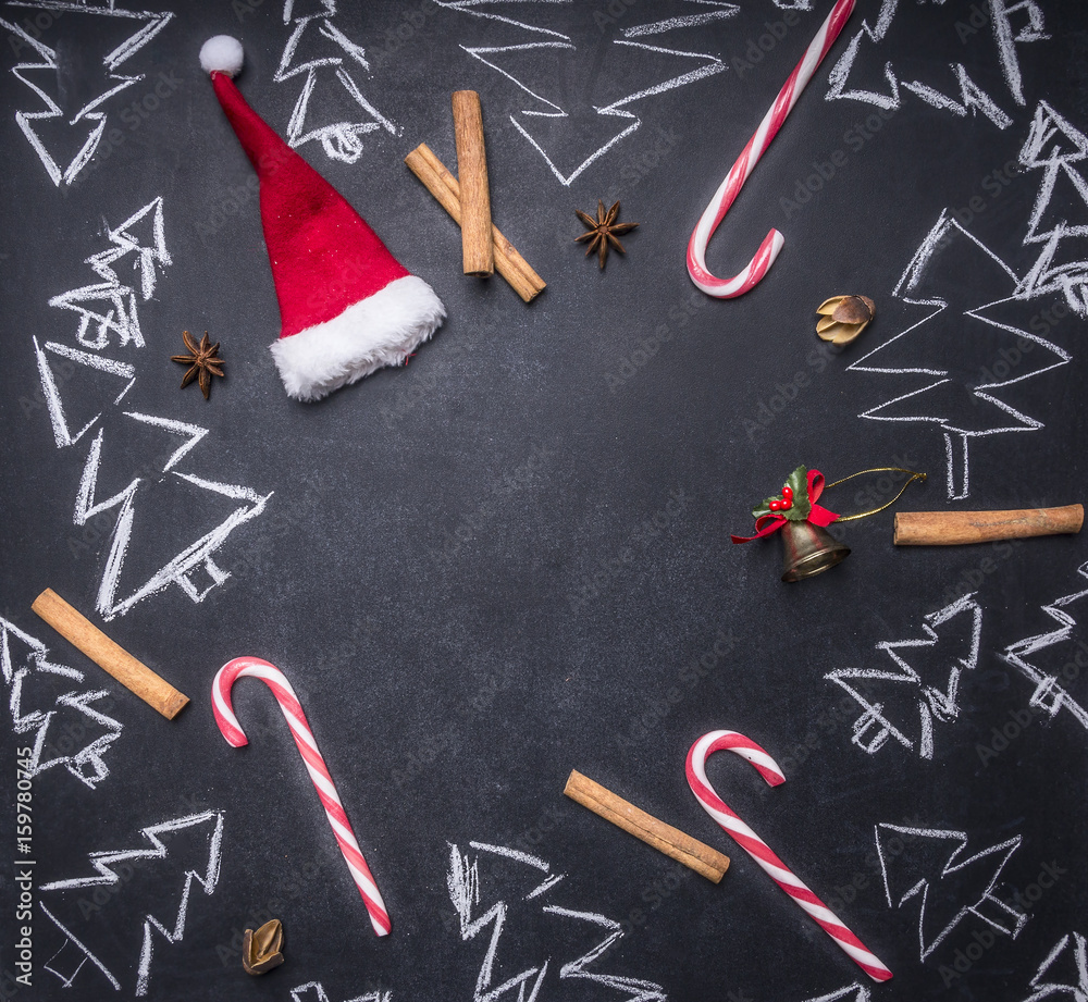 chalk board with painted Christmas decorations, Christmas trees, candy, cups and ingredients for mulled wine, tiled frame, space for text, top view chalk board with painted Christmas decorations, Christmas trees, candy, cups and ingredients for mulled wine, tiled frame, space for text, top view