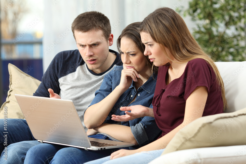 Angry friends watching content on a laptop Angry friends watching content on a laptop