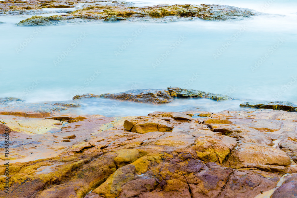 Colourful rocks and water at Diamond Head coast, Australia