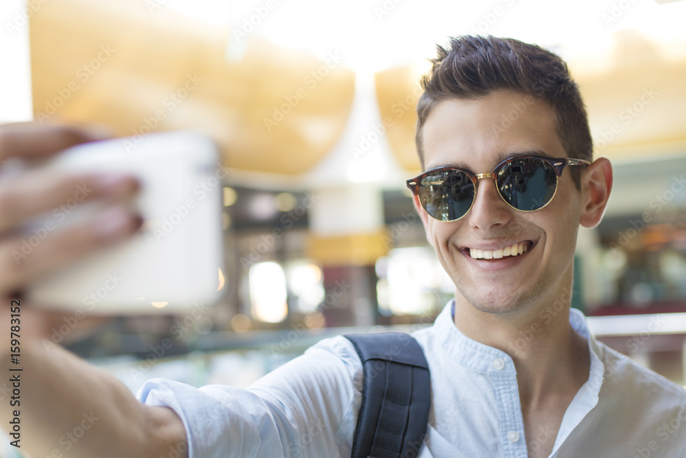 young teenager taking pictures with your mobile phone