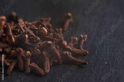 Macro photo of cloves spices on dark background.     Can be used for food blogs, food prints or designs and etc.