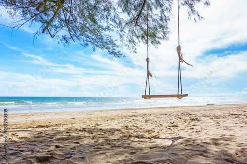 Wooden swing hanging from a tree on the beach   Chao Lao Beach  Chanthaburi in Thailand.