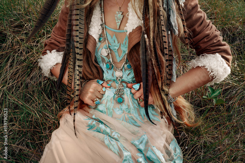 beautiful young boho girl with feathers close up