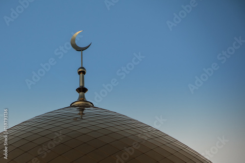 The Golden Crescent. Golden minaret of the mosque. Muslim symbol.Sunset or sunrise the sky.