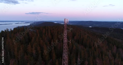 Koli, Cinema 4k aerial view around a radiotower and over koli mountain, on a spring sunset evening, in Lieksa, Karelia, Finland photo