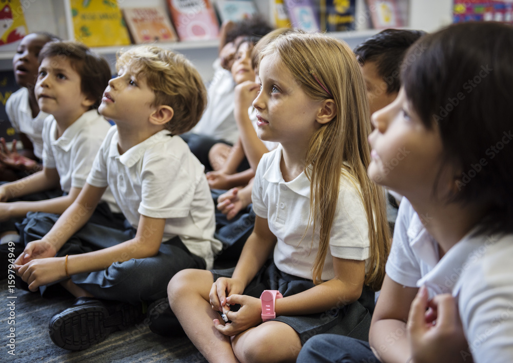 Kindergarten students sitting on the floor Kindergarten students sitting on the floor