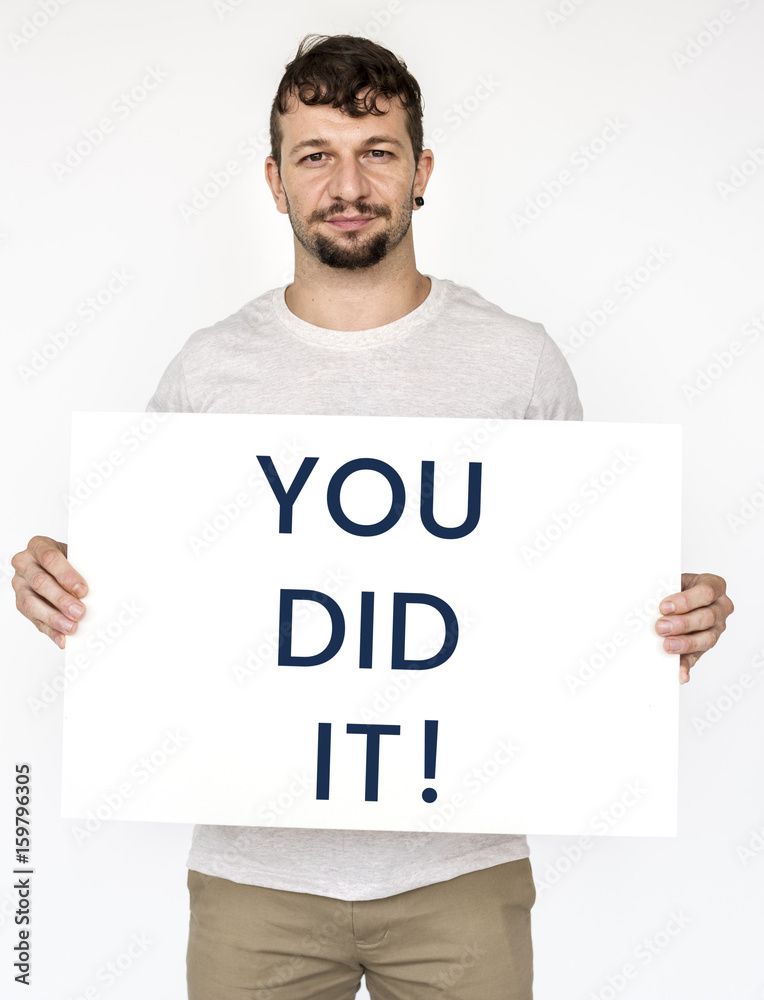 Man holding board with aspiration motivation word Man holding board with aspiration motivation word