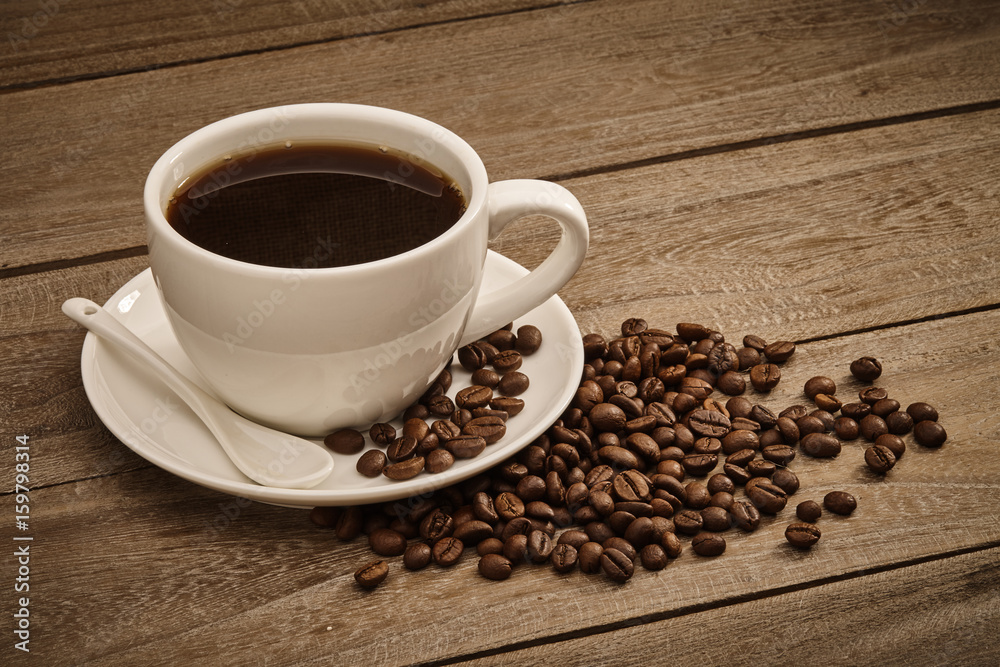 Cup of coffee and coffee beans with wooden table Cup of coffee and coffee beans with wooden table