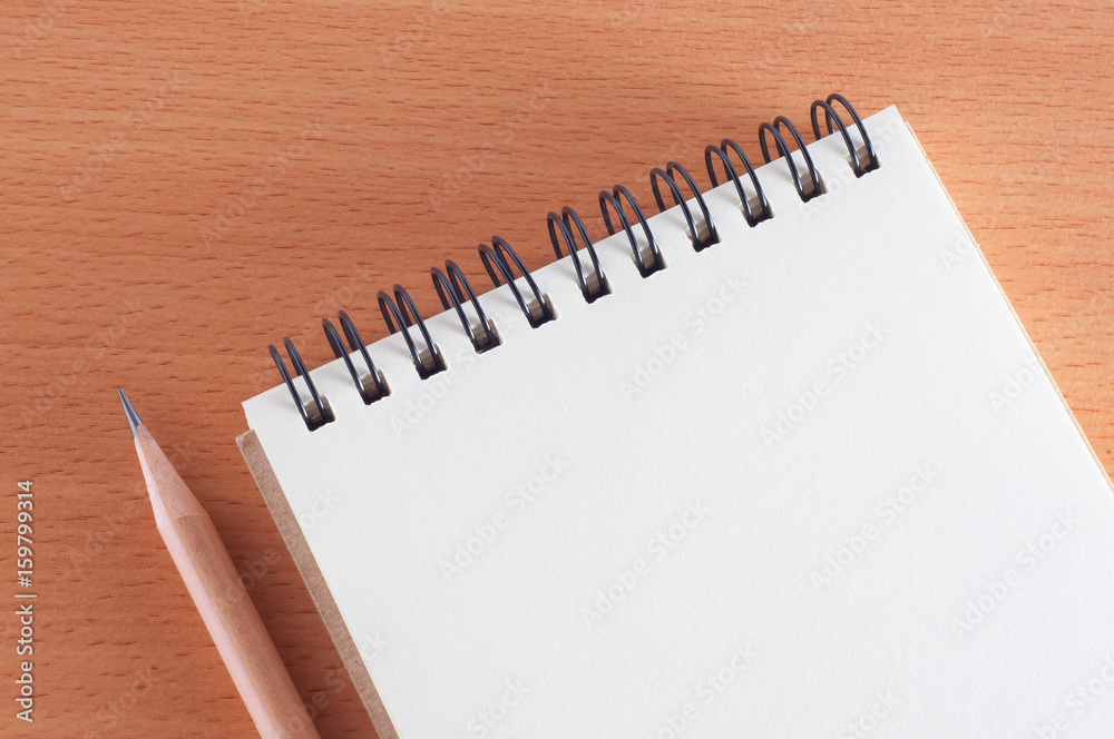 blank spiral notebook with a pencil on wooden desk blank spiral notebook with a pencil on wooden desk