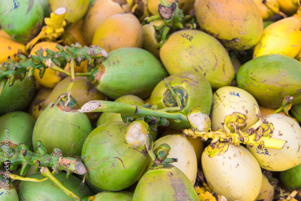 Fresh raw yellow and green coconuts fruits in Male,Maldives