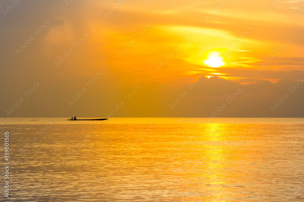 Silhouette fishing boat and Reflection of sunlight on the sea, sunrise in the sea