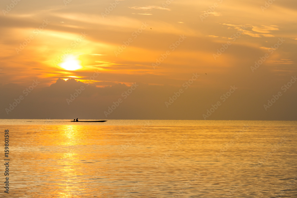 Silhouette fishing boat and Reflection of sunlight on the sea, sunrise in the sea