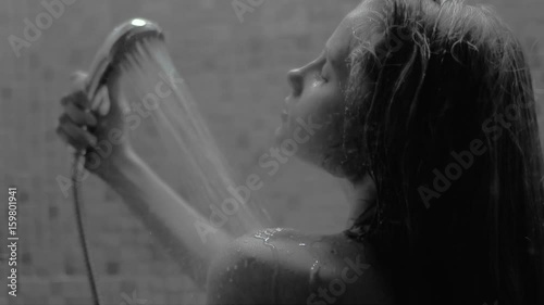 woman taking a shower in slow motion. beautiful girl enjoying herself during a shower.