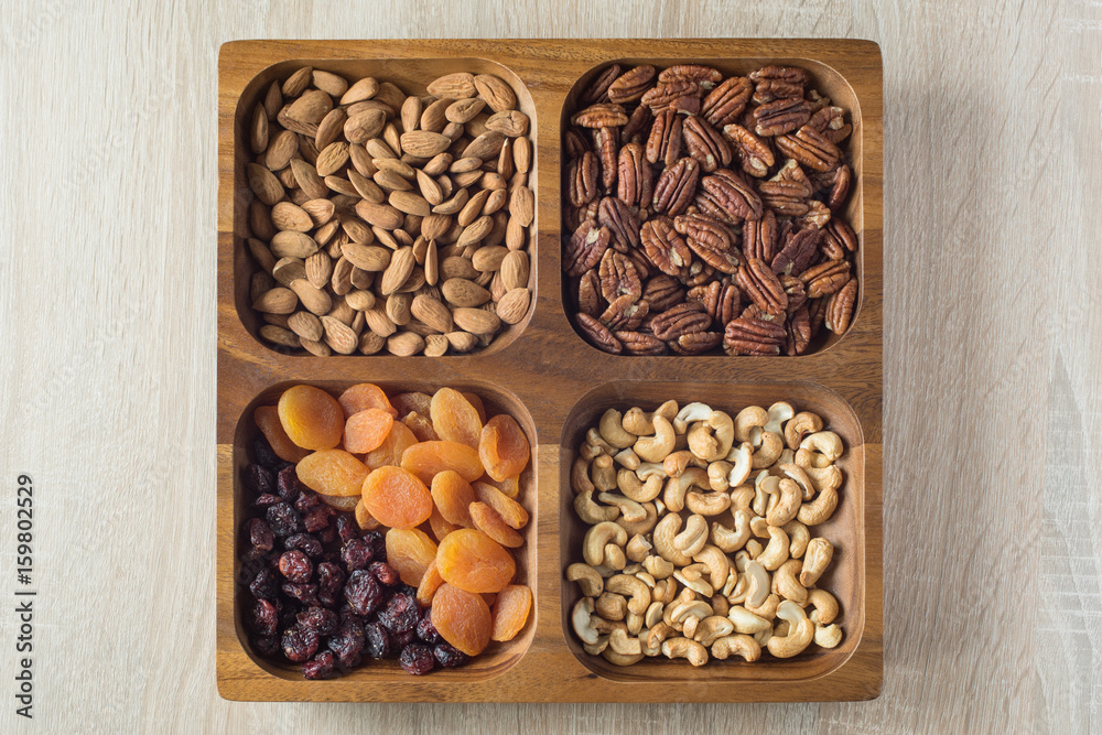 Assorted nuts and dried fruits in wooden box