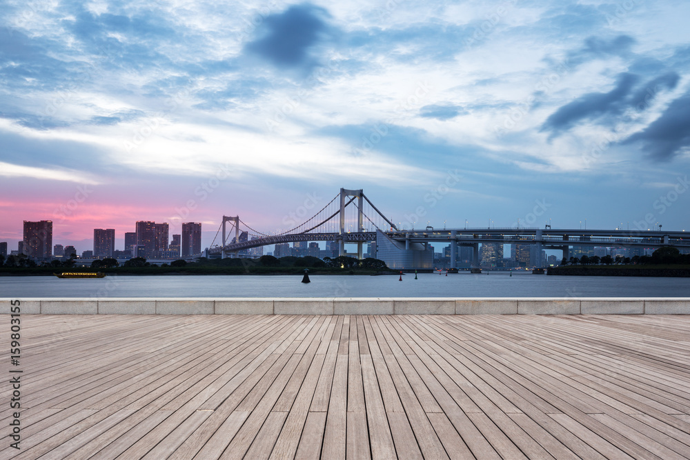 Fototapeta premium empty wooden pedestrians sidewalk with modern suspension bridge