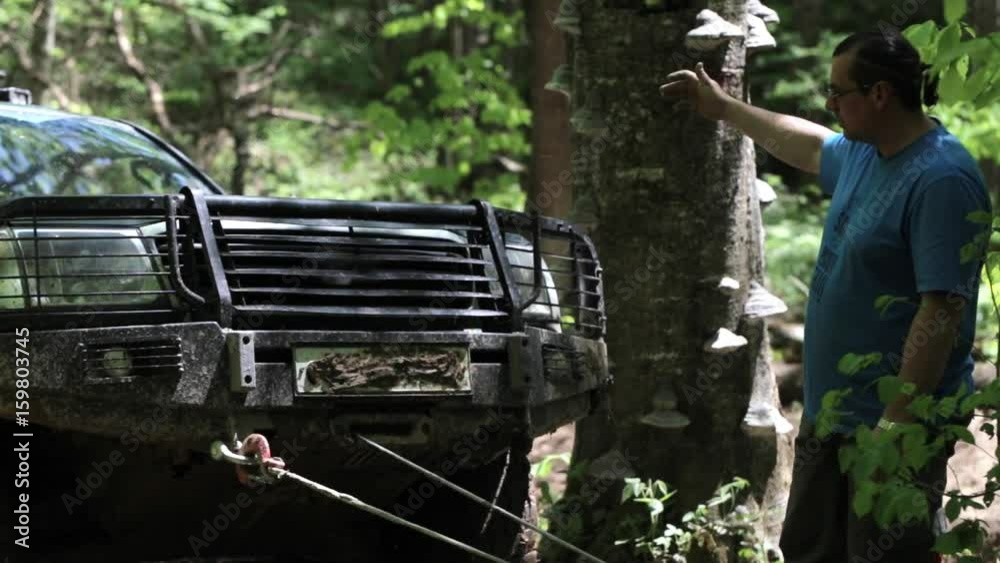 Expeditionary SUV got stuck in the forest and trying to get out via winch. Expeditionary SUV got stuck in the forest and trying to get out via winch.