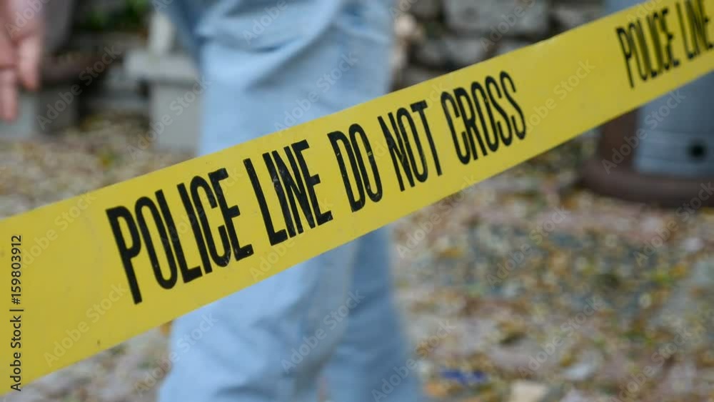 People walking behind a police line do not cross crime scene