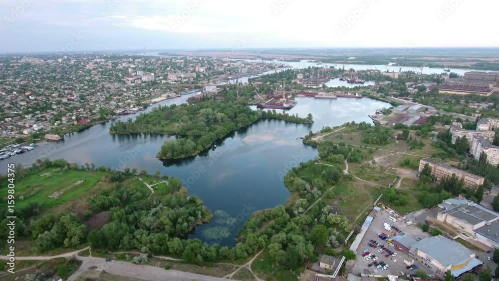 Amazing aerial shot of the Dnipro river and Kherson city outskirts with a nice embankment and hydropark in a sunny day in summer. The riverscape, nd cloudscape, look gorgeous and impressive. Amazing aerial shot of the Dnipro river and Kherson city outskirts with a nice embankment and hydropark in a sunny day in summer. The riverscape, nd cloudscape, look gorgeous and impressive.