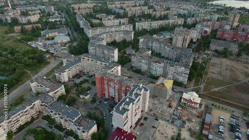 Heart breaking view on Kherson city in Ukraine from bird`s eye perspective with multistoreyed apartment blocks, green streets, big round intersection, in a sunny day in summer. photo