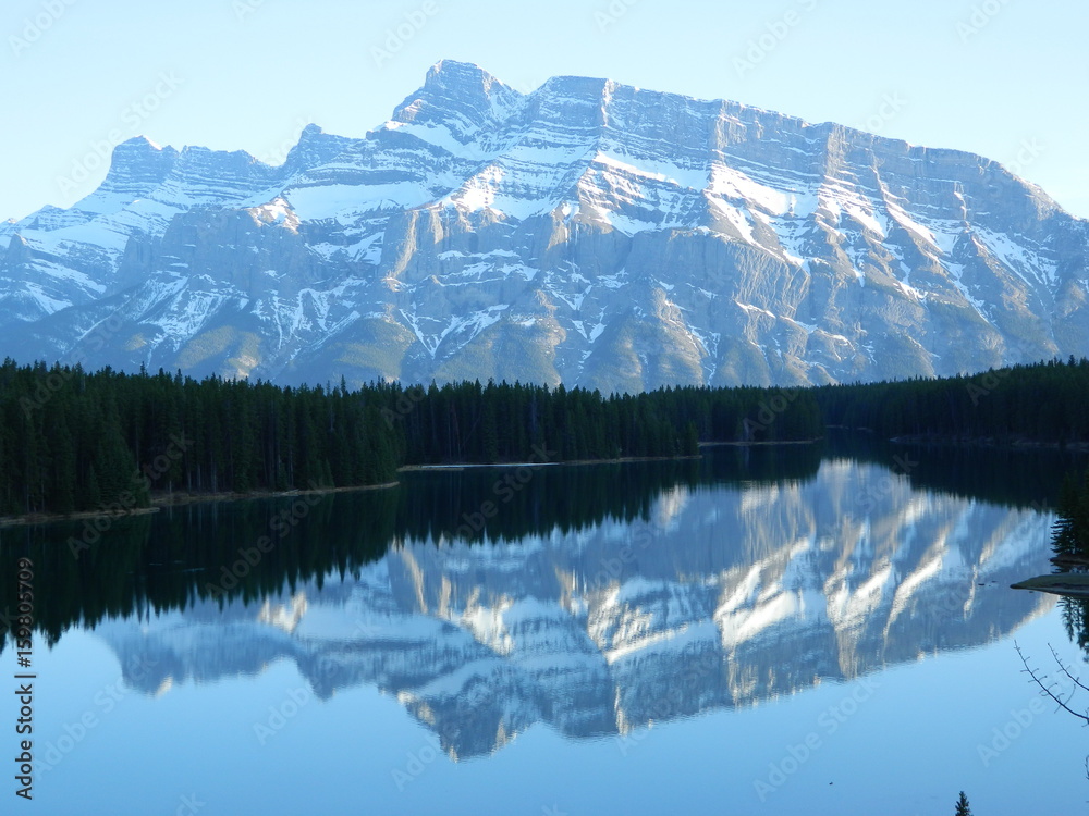 Fototapeta premium Beautiful Snowy Mountain Ridge with Reflection in a Clear Lake