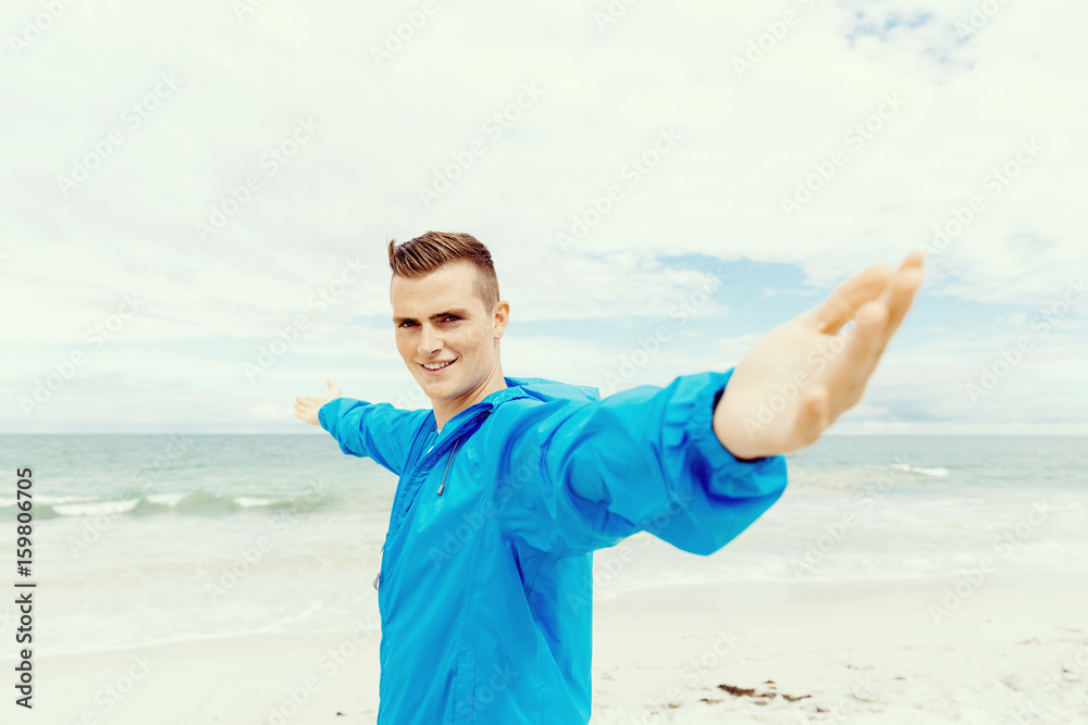 Young man in sport wear with outstretched arms Young man in sport wear with outstretched arms