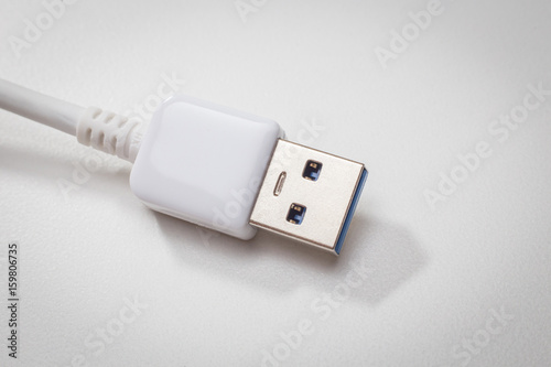 White usb 3.0 cable with micro B connector on white background close up image