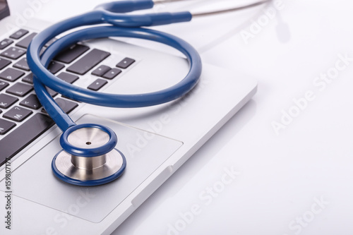 Computer notebook or laptop and stethoscope. Checking virus or damaged check up concept.