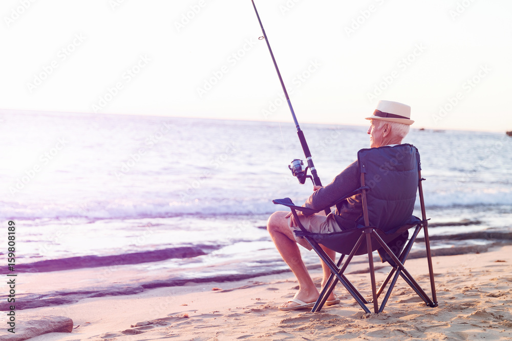 Senior man fishing at sea side Senior man fishing at sea side
