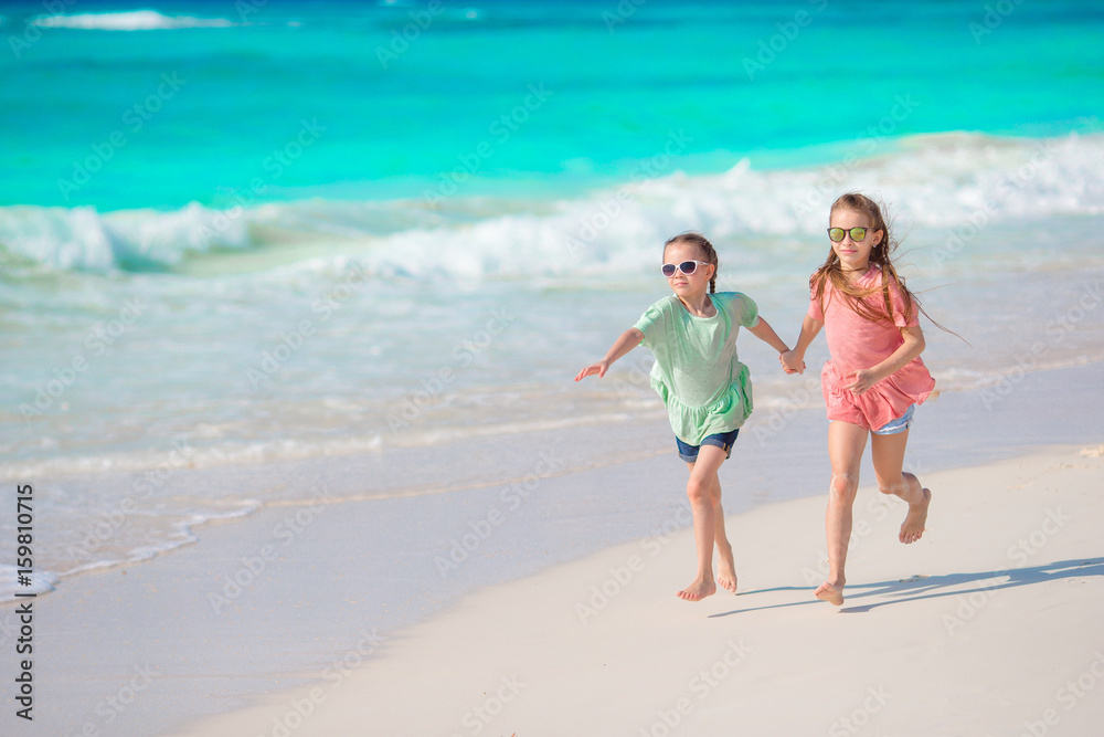 Kids enjoy their holidays on the beach running and having fun
