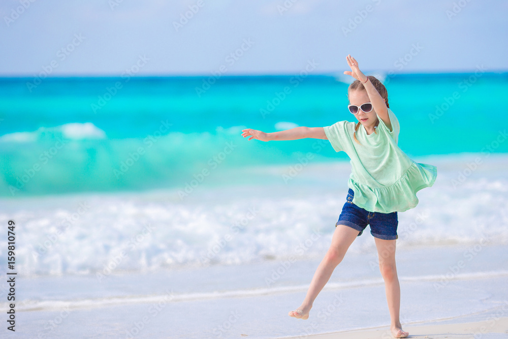 Adorable little girl at beach during summer vacation Adorable little girl at beach during summer vacation