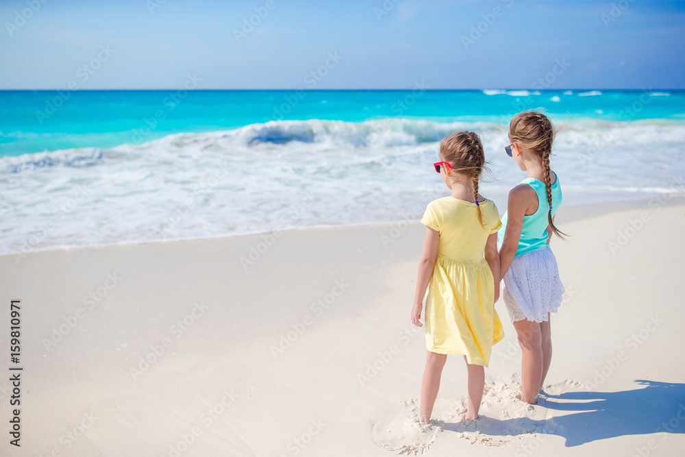 Adorable little girls together on the seashore
