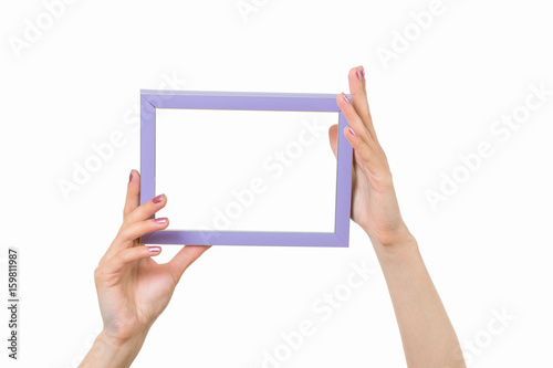 Frame in female hands on a white background