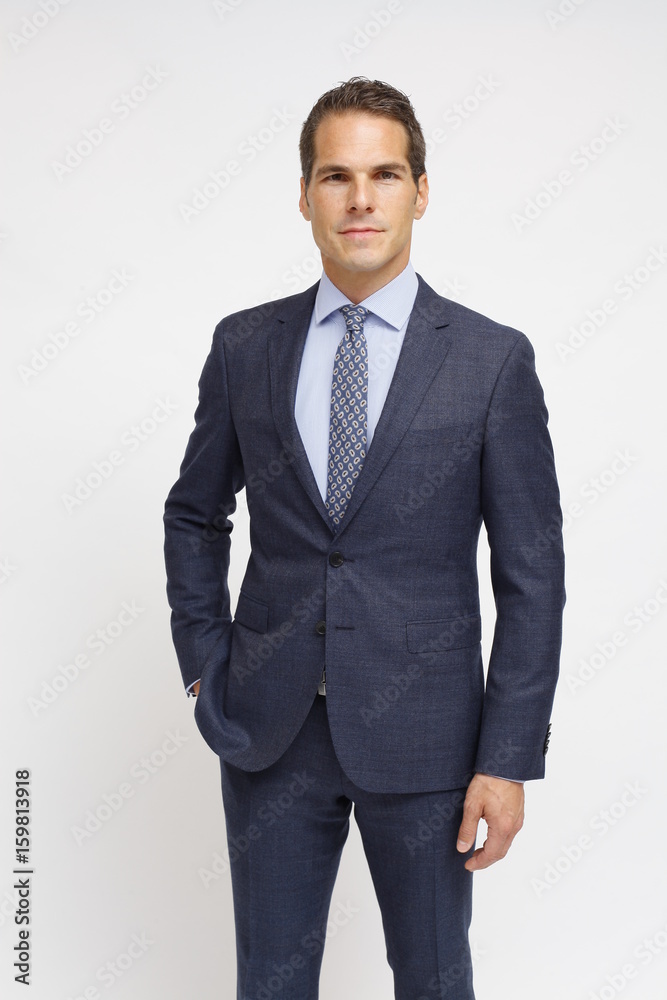 man with blue suit and a tie with patterns man with blue suit and a tie with patterns