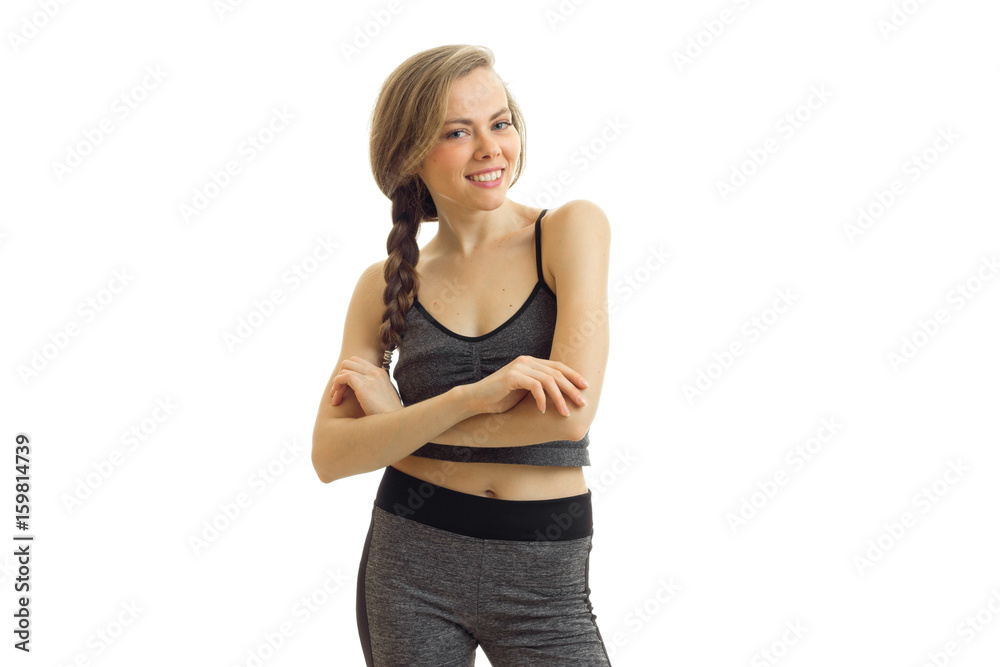 cheerful beautiful fitness blonde stands in front of the camera in sportswear and smiling cheerful beautiful fitness blonde stands in front of the camera in sportswear and smiling