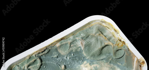 Принти на полотні Close up on rotten fresh cheese tub on black