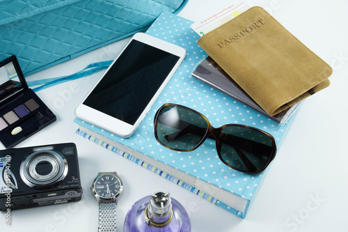 Planning for trip set of travel accessory and relax with notebook, sunglasses, passport, camera, mobile phone, parfume, luggage on white background, top view / copy space