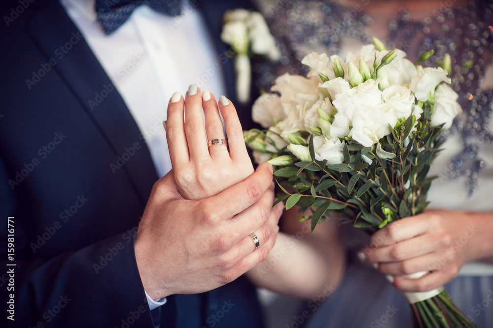Wedding bouquet and hands with rings Wedding bouquet and hands with rings