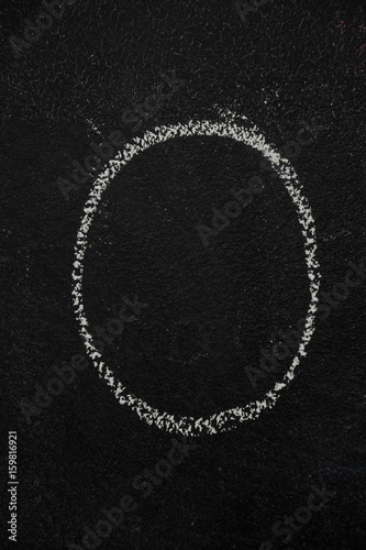 Letter O drawn with white chalk on blackboard. Education, school concept